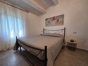 a bedroom with a bed and a large window at Locazione del cavaliere in Fano