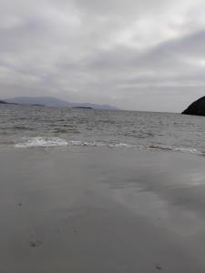 a beach with a body of water and the ocean at Teach Caitlin in Ballina +2 photos