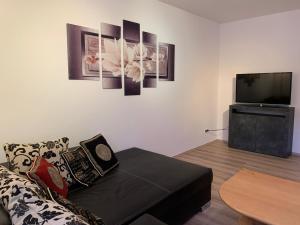 a living room with a couch and a flat screen tv at Schöne Ferienwohnung bei Lennestadt in Kirchhundem
