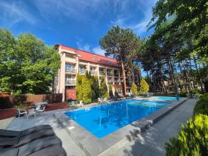a swimming pool in front of a building at Hotel Korona in Siófok +38 photos