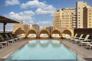 a pool on the roof of a building with lounge chairs at Hyatt Regency San Antonio Riverwalk in San Antonio