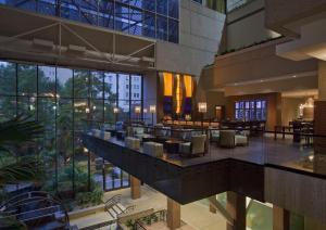 a hotel lobby with chairs and tables and windows at Hyatt Regency San Antonio Riverwalk in San Antonio