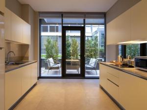 a kitchen with a large glass door leading to a patio at Movenpick Living Istanbul West in Istanbul +206 photos