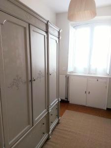 a large white cabinet in a room with a window at El Café I in Nava +11 photos