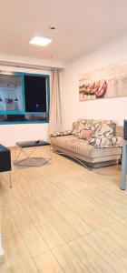 a living room with a bed and a wooden floor at טבריה 315 in Tiberias