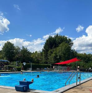 a large swimming pool with people in the water at Ferienwohnung zum Buchfeld in Windesheim