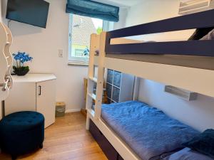 a bedroom with two bunk beds and a desk at Ferienwohnung zum Buchfeld in Windesheim +37 photos