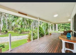 a house with a wooden deck with trees at Enchanted Garden Escape in Mowbray +33 photos