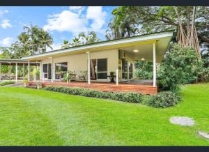 a home with a large deck in the yard at Enchanted Garden Escape in Mowbray