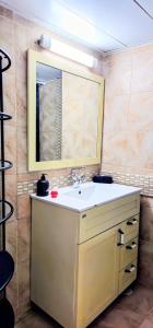 a bathroom with a sink and a mirror at טבריה 315 in Tiberias