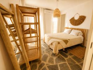 a small bedroom with a bed and a ladder at Finca Dariana Padel & Pool in Alora +67 photos