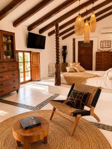 a large bedroom with two beds and a table at Finca Dariana Padel & Pool in Alora