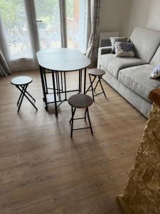 a living room with a table and a couch at Studio avec cheminée et jardin in Gréolières