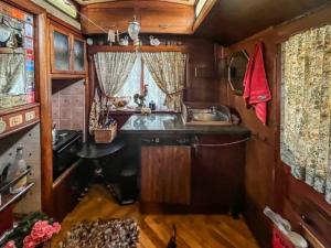 a small kitchen with a sink and a sink at Molly the Showman's Wagon in Hailsham