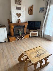 a living room with a fireplace and a coffee table at Studio avec cheminée et jardin in Gréolières