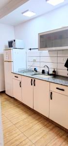 a kitchen with a sink and a refrigerator at טבריה 315 in Tiberias