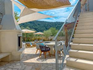 a patio with stairs and a table and chairs at Dolce Terra in Stari Grad