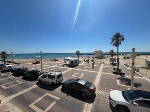 a parking lot at the beach with cars parked at Azure apartments Haifa in Haifa