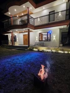 a fire pit in front of a house at night at Rahini sunset villa in Shimla