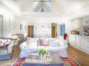 a living room with a couch and a bed at Dipper Boathouse in Acharn