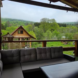 a living room with a couch and a large window at Pod Smerekiem in Wetlina
