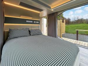 a bedroom with a bed in front of a window at Vessel 2 - Ukc9442 in Glasgow