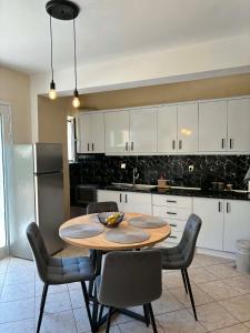a kitchen with a table and chairs in a kitchen at Noēma House I in Chóra