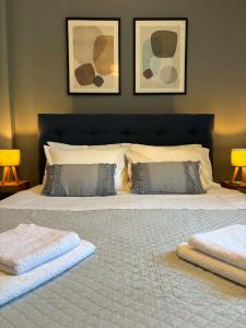 a bedroom with a large bed with two towels on it at Noēma House I in Chóra