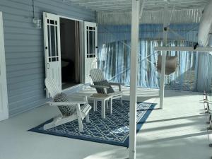 two chairs and a table on a porch at Flip flops in Horseshoe Bay