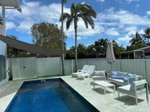 a patio with a swimming pool and chairs and avisor at Flip flops in Horseshoe Bay