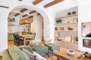 a living room with a table and chairs at Cal Moline Arrels - Refugio rural de diseño en el Berguedà in Graugés +38 photos