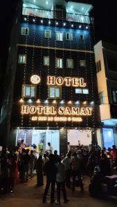 a crowd of people standing in front of a hotel at HOTEL SAMAY Rajgir in Rājgīr
