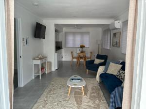 a living room with a blue couch and a table at Flip flops in Horseshoe Bay