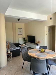 a living room with a table and a couch at Noēma House I in Chóra