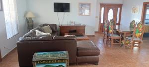 a living room with a couch and a table at Casa Lagunita in Ensenada