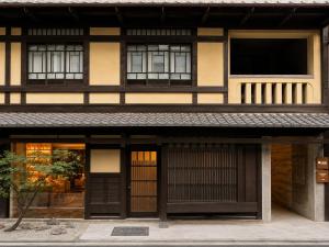 an asian building with black doors and windows at KIORI Collection Gokomachi in Kyoto