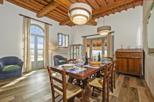 a dining room with a wooden table and chairs at Fontesecca - Happy Rentals in Città della Pieve +35 photos