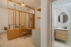 a bathroom with a sink and a mirror at Marilia Studios in Livadakia +12 photos