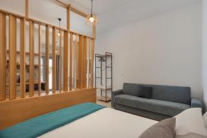 a bedroom with a bed and a couch at Marilia Studios in Livadakia