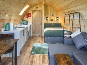 a living room with a bed in a tiny house at Oak - Uk51863 in Reighton
