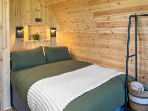 a bed in a room with a wooden wall at Oak - Uk51863 in Reighton
