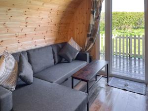 a living room with a couch and a table at Oak - Uk51863 in Reighton