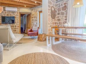a living room with a stone wall at Dolce Terra in Stari Grad
