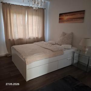 a bed in a room with a window and a bed frame at Casa Calali haustierfreundlich u barrierefrei in Bad Endbach