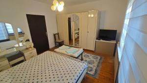 a room with two beds and a mirror in it at Prenoćište Dika in Višegrad
