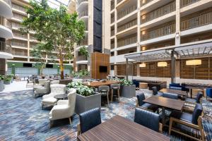 an exterior view of a restaurant with tables and chairs at Embassy Suites by Hilton Minneapolis Bloomington Edina in Bloomington