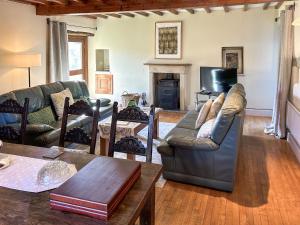 a living room with a couch and a table at Ostlers End in Hartington