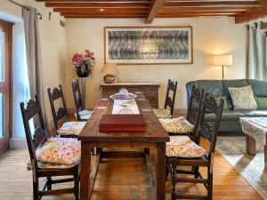 a dining room with a wooden table and chairs at Ostlers End in Hartington