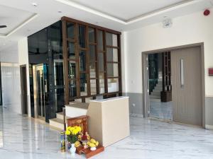 a lobby of a building with a door and flowers at Cozy Corner Beach Hotel in Phú Quốc