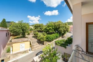 a balcony with a view of a street and trees at Sa concia in Teulada